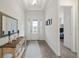 Bright entryway with decorative mirror and console table at 11398 Juglans Dr, Odessa, FL 33556