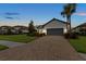 Charming single-story home with a well-manicured lawn, paved driveway, and gray accents at 11398 Juglans Dr, Odessa, FL 33556