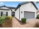 A well-maintained front entrance with brick walkway, tidy landscaping, and a welcoming gray garage door at 11398 Juglans Dr, Odessa, FL 33556