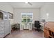 Spacious home office with large window, tiled floors, and multiple desk spaces at 11398 Juglans Dr, Odessa, FL 33556
