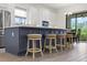Bright kitchen boasts stainless appliances, gray cabinets and an island with seating at 11398 Juglans Dr, Odessa, FL 33556