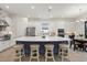 Bright kitchen boasts white cabinets, stainless appliances, and a large island with seating at 11398 Juglans Dr, Odessa, FL 33556