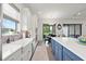 Bright kitchen with view to water boasts stainless appliances and island with seating at 11398 Juglans Dr, Odessa, FL 33556