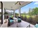 Screened lanai featuring ceiling fans and comfortable wicker seating overlooking the yard at 11398 Juglans Dr, Odessa, FL 33556