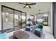 Expansive covered lanai with wicker seating and large sliding doors to living areas at 11398 Juglans Dr, Odessa, FL 33556