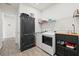 Well-equipped laundry room featuring washer, dryer, storage, and stylish decor at 11398 Juglans Dr, Odessa, FL 33556