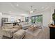 Bright and spacious living room flows into the kitchen, featuring stylish furnishings, and plenty of natural light at 11398 Juglans Dr, Odessa, FL 33556