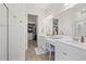 Main bathroom with double sinks, granite counters, a walk-in closet, and a walk-in shower at 11398 Juglans Dr, Odessa, FL 33556