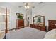 Spacious main bedroom showcasing a four-poster bed, dresser, walk-in closet, and en-suite bathroom at 11398 Juglans Dr, Odessa, FL 33556