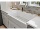 Farmhouse sink with stainless steel faucet and brick backsplash at 11398 Juglans Dr, Odessa, FL 33556