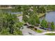 A street and walking path view of the street into the community with beautiful landscaping and lake views at 11398 Juglans Dr, Odessa, FL 33556