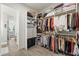 Organized walk-in closet featuring custom shelves for clothing and accessories at 11398 Juglans Dr, Odessa, FL 33556