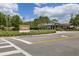 Community Welcome Center with a sign, attractive landscaping, and modern architecture creates a welcoming atmosphere at 11398 Juglans Dr, Odessa, FL 33556