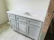 Bathroom featuring light grey vanity with solid surface top and storage cabinets at 11406 Labrador Duck Rd, Weeki Wachee, FL 34614