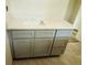 Bathroom vanity with gray cabinets and a white countertop, perfect for a modern aesthetic at 11406 Labrador Duck Rd, Weeki Wachee, FL 34614