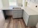 Kitchen with gray shaker cabinets, white countertops, and stainless sink at 11406 Labrador Duck Rd, Weeki Wachee, FL 34614