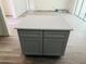 Kitchen island featuring gray shaker cabinets and a white countertop at 11406 Labrador Duck Rd, Weeki Wachee, FL 34614