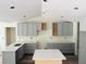 A well-lit kitchen with gray cabinets, modern countertops, and an island, ready for finishing touches at 11406 Labrador Duck Rd, Weeki Wachee, FL 34614