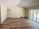 Living room featuring a sliding glass door and modern flooring at 11406 Labrador Duck Rd, Weeki Wachee, FL 34614