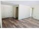 Living room featuring wood-look floors, a front door, and several interior doors ready to be installed at 11406 Labrador Duck Rd, Weeki Wachee, FL 34614