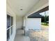 Home porch featuring sleek white columns and a view of surrounding landscape at 11406 Labrador Duck Rd, Weeki Wachee, FL 34614