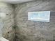 Walk-in shower features tiled walls and a window at 11406 Labrador Duck Rd, Weeki Wachee, FL 34614