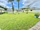 Well-maintained backyard with a lush lawn and mature trees, adding natural beauty and shade to the property at 11619 Boynton Ln, New Port Richey, FL 34654