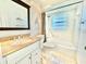 Bathroom with granite vanity, a shower-tub combination, and bright, clean finishes at 11619 Boynton Ln, New Port Richey, FL 34654