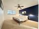 Bedroom with a black metal bed frame, a ceiling fan and blue accent wall at 11619 Boynton Ln, New Port Richey, FL 34654