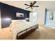 Inviting bedroom boasts a dark accent wall, ceiling fan, and neutral carpeting at 11619 Boynton Ln, New Port Richey, FL 34654