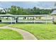 A view of a spacious carport, complemented by a green lawn and beautifully landscaped areas at 11619 Boynton Ln, New Port Richey, FL 34654