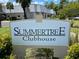 Community clubhouse sign with lush landscaping, indicating a welcoming environment at 11619 Boynton Ln, New Port Richey, FL 34654