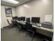 Community computer room featuring multiple workstations, chairs, and printing facilities for residents at 11619 Boynton Ln, New Port Richey, FL 34654