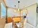 Cozy dining room with wood table, pendant lighting, and built-in storage cabinets at 11619 Boynton Ln, New Port Richey, FL 34654