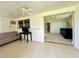 The living room is connected to the laundry room and another bedroom via hallways at 11619 Boynton Ln, New Port Richey, FL 34654