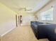 Living room featuring neutral carpet flooring, natural light, and closet access at 11619 Boynton Ln, New Port Richey, FL 34654