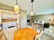 Bright living space features a kitchen with white cabinets, a wooden dining table, and a comfortable seating area at 11619 Boynton Ln, New Port Richey, FL 34654