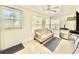 Bright sunroom with tiled floors, multiple windows offering natural light, and comfortable seating at 11619 Boynton Ln, New Port Richey, FL 34654
