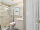Bright bathroom with a glass-enclosed shower and white vanity at 11752 Wheatfield Loop, Hudson, FL 34667