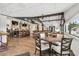 Dining area with hardwood floors, tables, chairs, and a view of the bar at 11752 Wheatfield Loop, Hudson, FL 34667