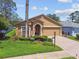 Charming single-story home with a well-manicured lawn and colorful landscaping at 11752 Wheatfield Loop, Hudson, FL 34667