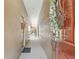 Neutral colored hallway with decoratively textured walls, a white ceiling, and dark brown doors at 11752 Wheatfield Loop, Hudson, FL 34667