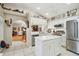 Modern kitchen with island, stainless steel appliances, and open layout to living area at 11752 Wheatfield Loop, Hudson, FL 34667