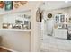Modern, well-lit kitchen with white cabinets, stainless steel appliances, and tile floors at 11752 Wheatfield Loop, Hudson, FL 34667