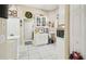 Bright kitchen featuring white cabinets, tile flooring, and stylish decor at 11752 Wheatfield Loop, Hudson, FL 34667