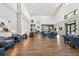 Spacious lobby with high ceilings, comfortable seating, and hardwood floors at 11752 Wheatfield Loop, Hudson, FL 34667