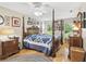 Spacious main bedroom with a ceiling fan, wood floors, and natural light at 11752 Wheatfield Loop, Hudson, FL 34667