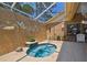 Enclosed pool/spa area with a private water feature at 11752 Wheatfield Loop, Hudson, FL 34667