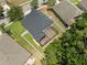 Aerial view showcases fenced backyard with screened lanai and well-maintained lawn at 12055 Colony Lakes Blvd, New Port Richey, FL 34654