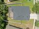 Aerial view showcases the home's backyard featuring a screened lanai, white fence, and landscaping at 12055 Colony Lakes Blvd, New Port Richey, FL 34654
